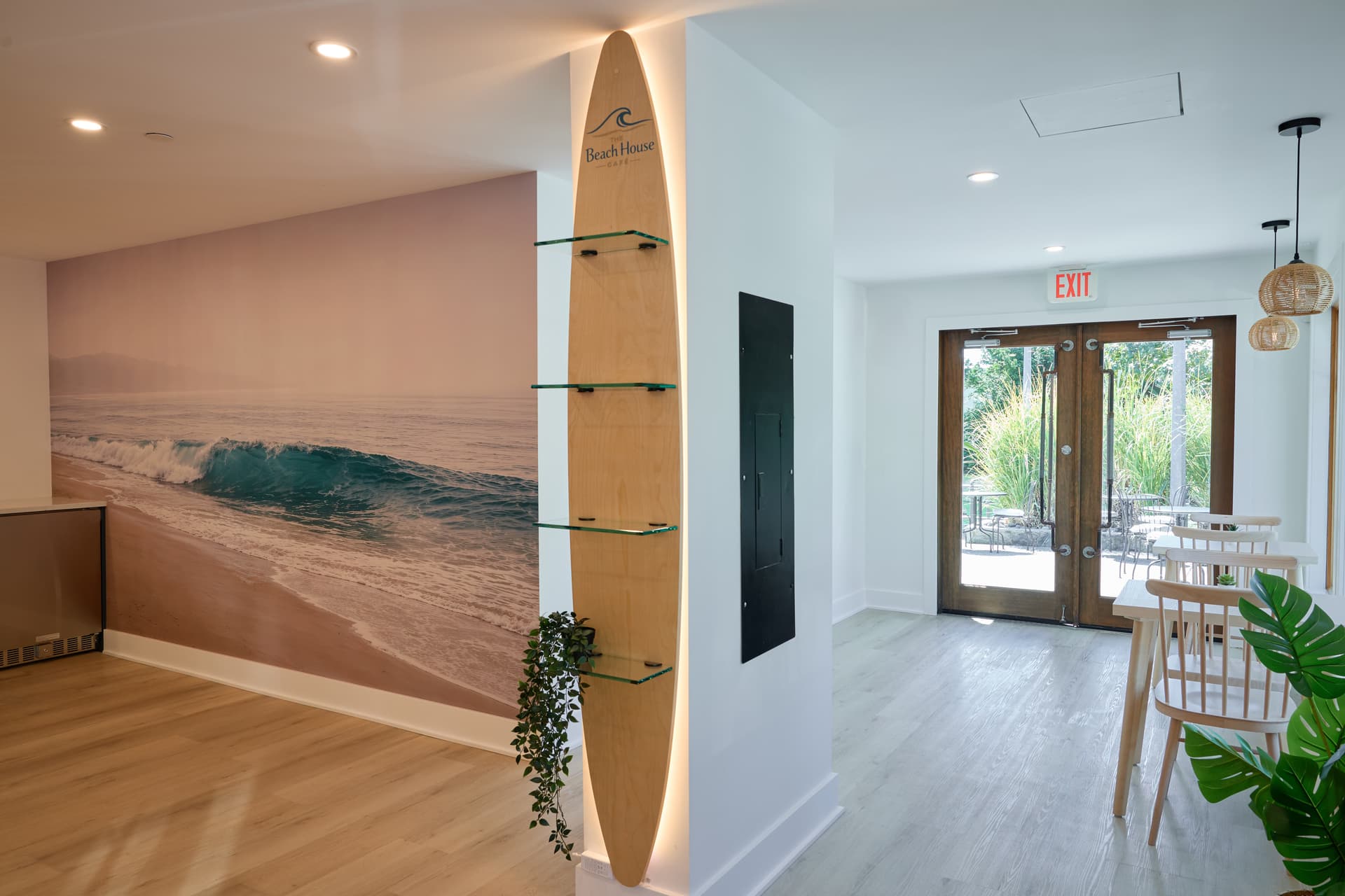 Café interior featuring a custom surfboard display and beach mural